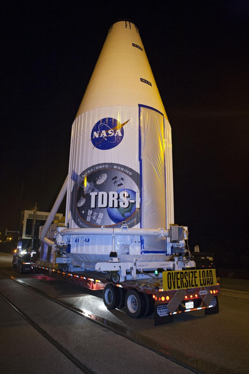 CAPE CANAVERAL, Fla. –NASA's Tracking and Data Relay Satellite, TDRS-K, enclosed in its payload fairing, passes through the Launch Complex 39 area at NASA's Kennedy Space Center as it travels from the Astrotech payload processing facility in Titusville, Fla., to its launch site. TDRS-K will lift off atop a United Launch Alliance Atlas V rocket from Cape Canaveral Air Force Station's Space Launch Complex 41. The TDRS-K spacecraft is part of the next-generation series in the Tracking and Data Relay Satellite System, a constellation of space-based communication satellites providing tracking, telemetry, command and high-bandwidth data return services. For more information, go to http://www.nasa.gov/tdrs Photo credit: NASA/Glenn Benson