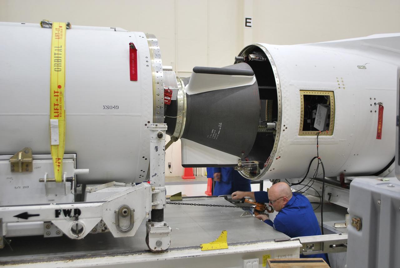 VANDENBERG AFB, Calif. – A technician moves the second stage of an Orbital Sciences Pegasus rocket into the first stage before a separation test is conducted. The Pegasus is being processed to launch NASA's Interface Region Imaging Spectrograph mission, known as IRIS. Photo credit: Randy Beaudoin, VAFB