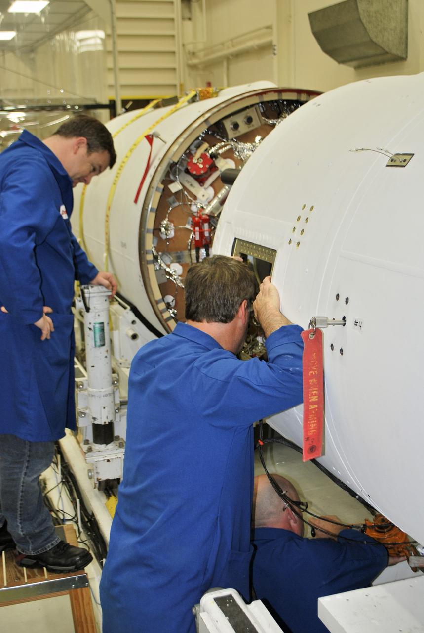 VANDENBERG AFB, Calif. – Technicians monitor the movement of the second stage of an Orbital Sciences Pegasus rocket into the first stage before a separation test is conducted. The Pegasus is being processed to launch NASA's Interface Region Imaging Spectrograph mission, known as IRIS. Photo credit: Randy Beaudoin, VAFB
