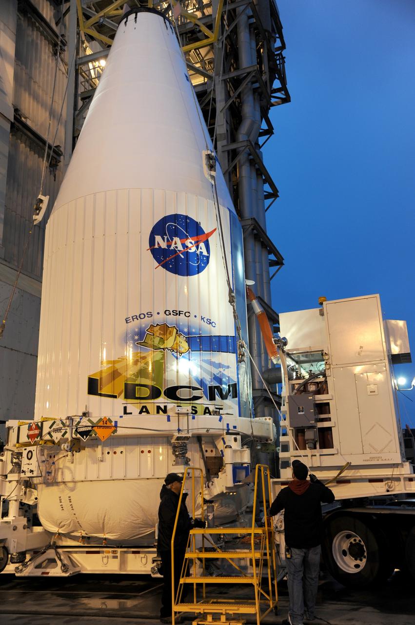 VANDENBERG AIR FORCE BASE, Calif. --- Loaded on a transporter, the payload faring containing the Landsat Data Continuity Mission LDCM spacecraft arrives at Vandenberg Air Force Base's Space Launch Complex-3E where it will be hoisted atop a United Launch Alliance Atlas V for launch. LDCM is the eighth satellite in the Landsat Program series of Earth-observing missions jointly managed by NASA and the U.S. Geological Survey. LDCM will continue the program’s critical role in monitoring, understanding and managing the resources needed for human sustainment such as food, water and forests. Photo credit: NASA/VAFB