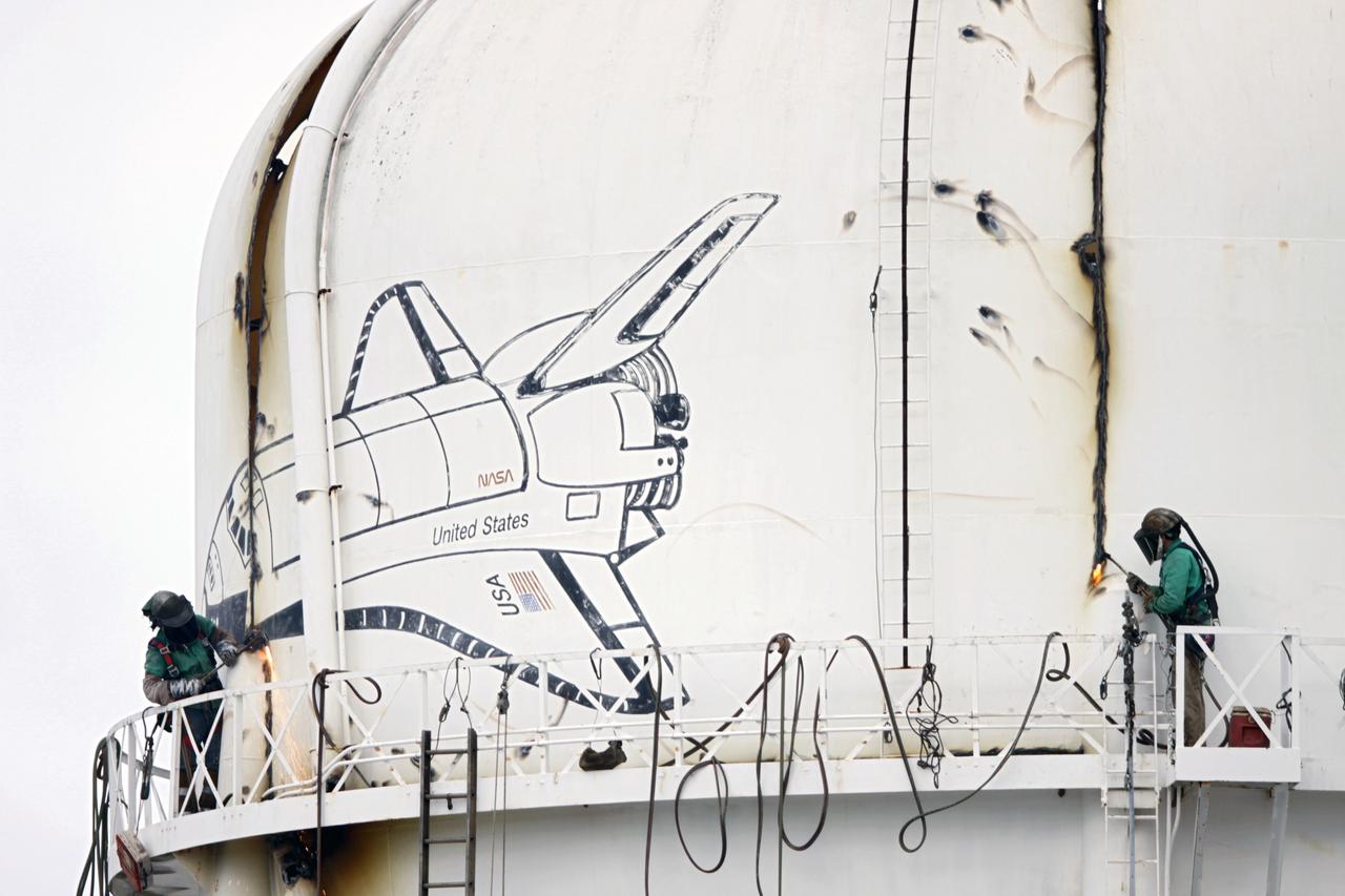 CAPE CANAVERAL, Fla. – Workers use a cutting torch to dismantle a water tower in the Launch Complex 39 area at NASA’s Kennedy Space Center in Florida. The effort is part of on-going efforts to upgrade and revitalize Kennedy's water and sewer systems to increase their reliability, sustainability and capabilities into the 21st century for current and future users. For more information, visit: http://kscpartnerships.ksc.nasa.gov/masterPlan/spaceportConcept.htm Photo credit: NASA/Tim Jacobs