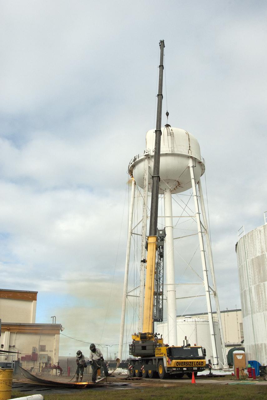 CAPE CANAVERAL, Fla. – Workers use a cutting torch to dismantle parts of a water tower in the Launch Complex 39 area at NASA’s Kennedy Space Center in Florida. The effort is part of on-going efforts to upgrade and revitalize Kennedy's water and sewer systems to increase their reliability, sustainability and capabilities into the 21st century for current and future users. For more information, visit: http://kscpartnerships.ksc.nasa.gov/masterPlan/spaceportConcept.htm Photo credit: NASA/Jim Grossmann
