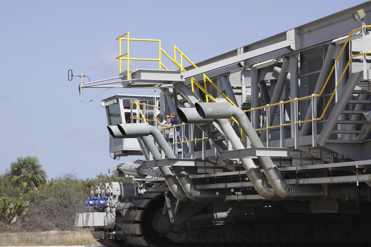 CAPE CANAVERAL, Fla. – At NASA’s Kennedy Space Center in Florida, technicians monitor the progress as crawler-transporter 2, or CT-2, is moved from the Vehicle Assembly Building to the Park Site west of the building. The transporter has new brakes and mufflers and a recently-painted white roof deck. The Ground Systems Development and Operations Program office at Kennedy is overseeing the upgrades to CT-2 so that it can carry NASA’s Space Launch System heavy-lift rocket, which is under design, and new Orion spacecraft to the launch pad. The crawler-transporters were used to carry the mobile launcher platform and space shuttle to Launch Complex 39 for space shuttle launches for 30 years. Photo credit: NASA/Jim Grossmann