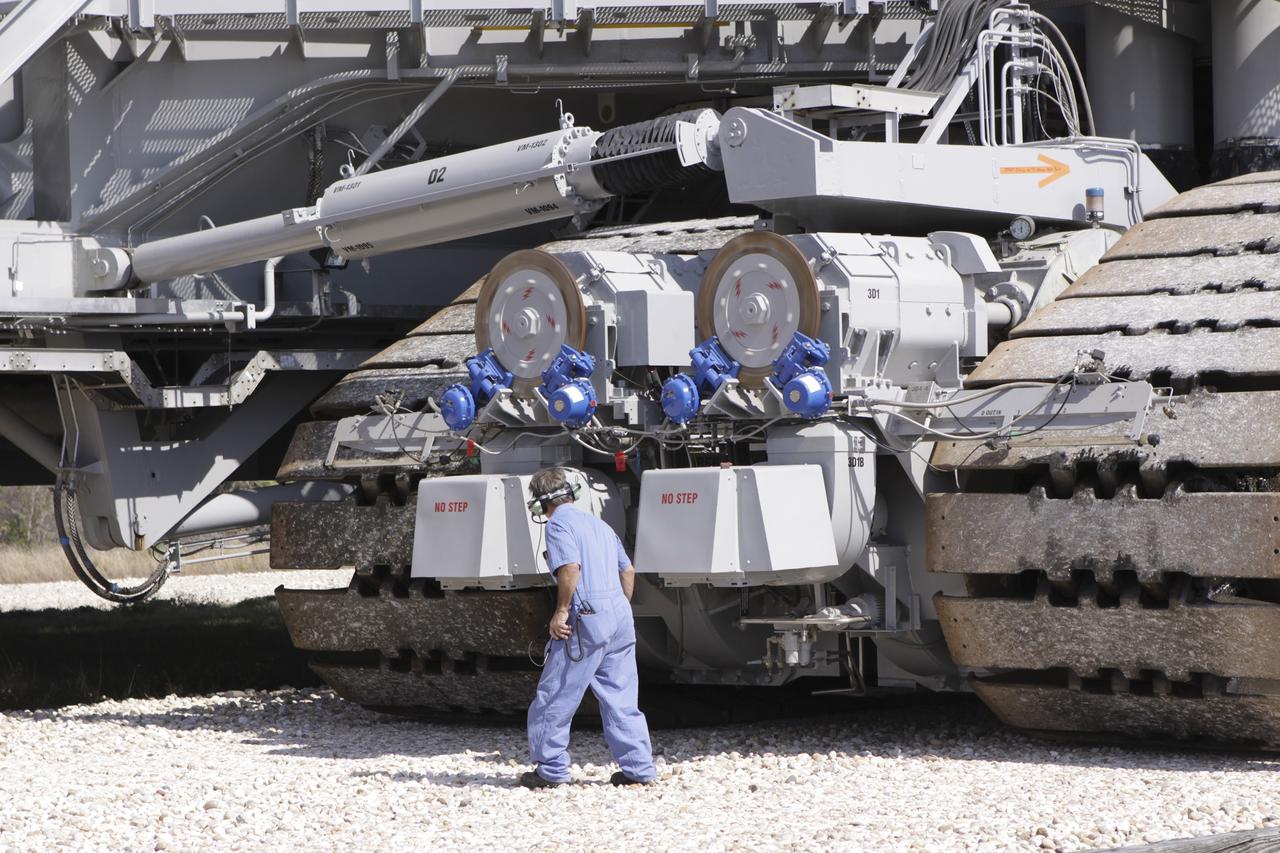 CAPE CANAVERAL, Fla. – At NASA’s Kennedy Space Center in Florida, technicians monitor the progress as crawler-transporter 2, or CT-2, is moved from the Vehicle Assembly Building to the Park Site west of the building. The transporter has new brakes and mufflers and a recently-painted white roof deck. The Ground Systems Development and Operations Program office at Kennedy is overseeing the upgrades to CT-2 so that it can carry NASA’s Space Launch System heavy-lift rocket, which is under design, and new Orion spacecraft to the launch pad. The crawler-transporters were used to carry the mobile launcher platform and space shuttle to Launch Complex 39 for space shuttle launches for 30 years. Photo credit: NASA/Jim Grossmann