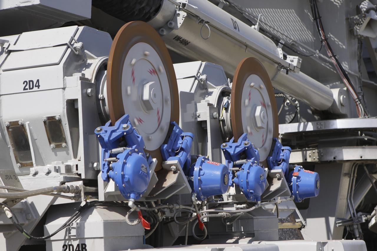 CAPE CANAVERAL, Fla. – At NASA’s Kennedy Space Center in Florida, the crawler-transporter 2, or CT-2, is moved from the Vehicle Assembly Building to the Park Site west of the building. A close-up view reveals new brakes and mufflers have been installed. CT-2 also has a recently-painted white roof deck. The Ground Systems Development and Operations Program office at Kennedy is overseeing the upgrades to CT-2 so that it can carry NASA’s Space Launch System heavy-lift rocket, which is under design, and new Orion spacecraft to the launch pad. The crawler-transporters were used to carry the mobile launcher platform and space shuttle to Launch Complex 39 for space shuttle launches for 30 years. Photo credit: NASA/Jim Grossmann