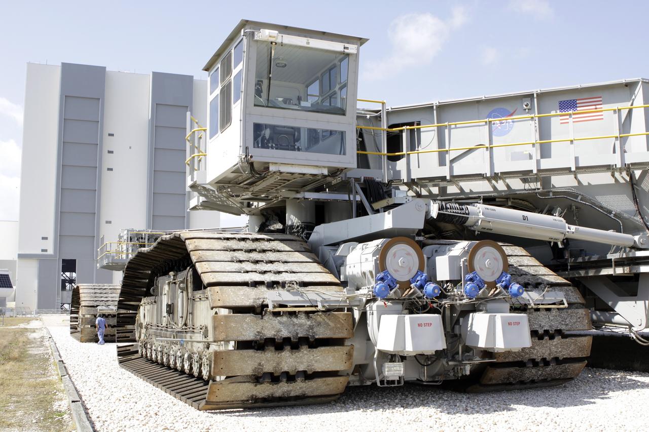 CAPE CANAVERAL, Fla. – At NASA’s Kennedy Space Center in Florida, technicians monitor the progress as crawler-transporter 2, or CT-2, is moved from the Vehicle Assembly Building to the Park Site west of the building. The transporter has new brakes and mufflers and a recently-painted white roof deck. The Ground Systems Development and Operations Program office at Kennedy is overseeing the upgrades to CT-2 so that it can carry NASA’s Space Launch System heavy-lift rocket, which is under design, and new Orion spacecraft to the launch pad. The crawler-transporters were used to carry the mobile launcher platform and space shuttle to Launch Complex 39 for space shuttle launches for 30 years. Photo credit: NASA/Jim Grossmann