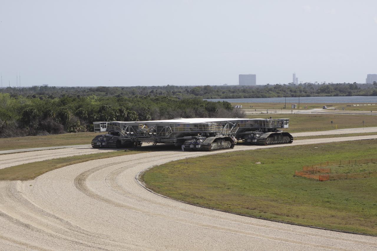 CAPE CANAVERAL, Fla. – At NASA’s Kennedy Space Center in Florida, the crawler-transporter 2, or CT-2, is on its way from the Vehicle Assembly Building to the Park Site west of the building. The transporter has new brakes and mufflers and a recently-painted white roof deck. The Ground Systems Development and Operations Program office at Kennedy is overseeing the upgrades to CT-2 so that it can carry NASA’s Space Launch System heavy-lift rocket, which is under design, and new Orion spacecraft to the launch pad. The crawler-transporters were used to carry the mobile launcher platform and space shuttle to Launch Complex 39 for space shuttle launches for 30 years. Photo credit: NASA/Jim Grossmann