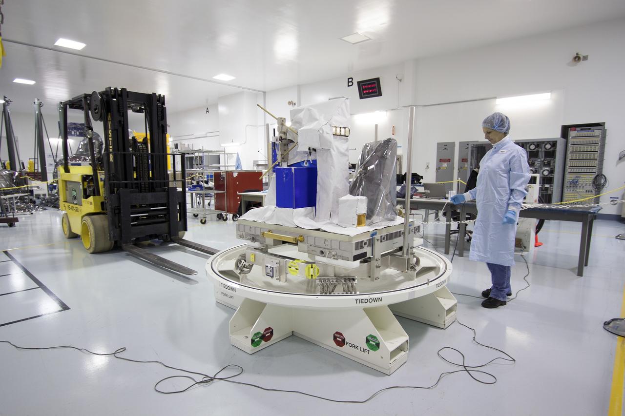 CAPE CANAVERAL, Fla. -- Inside the Space Station Processing Facility at NASA's Kennedy Space Center in Florida, technicians prepare to move the Space Test Program-Houston 4 experiment before installing the shipping container cover that will enclose it. The experiment is one of the payloads processed at Kennedy that will be flown to Japan for the HTV-4 launch to the station, which is currently scheduled for this summer. Photo credit: NASA/Jim Grossmann