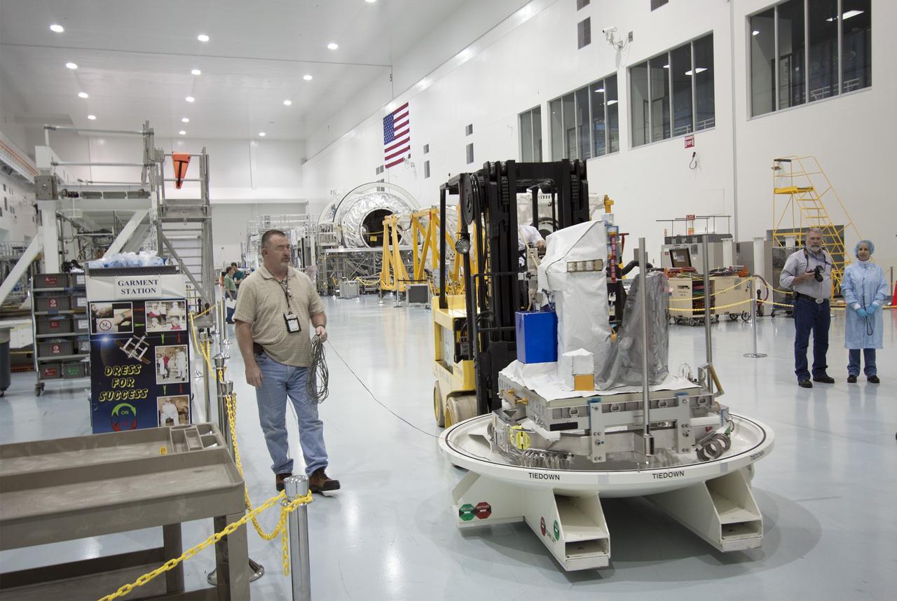 CAPE CANAVERAL, Fla. -- Inside the Space Station Processing Facility at NASA's Kennedy Space Center in Florida, technicians prepare to move the Space Test Program-Houston 4 experiment before installing the shipping container cover that will enclose. The experiment is one of the payloads processed at Kennedy that will be flown to Japan for the HTV-4 launch to the station, which is currently scheduled for this summer. Photo credit: NASA/Jim Grossmann