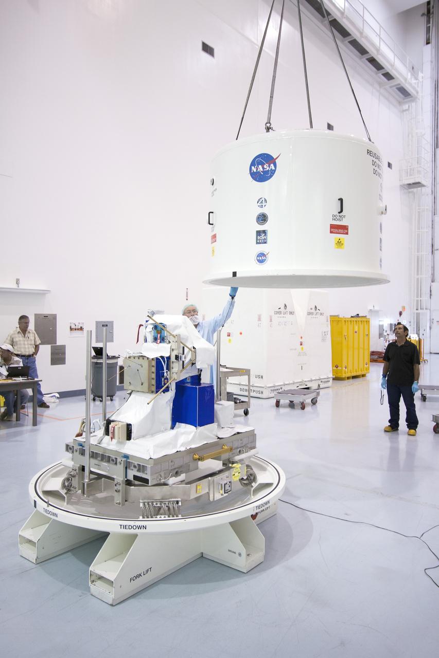 CAPE CANAVERAL, Fla. -- Inside the Space Station Processing Facility at NASA's Kennedy Space Center in Florida, technicians position the cover of the shipping container that will enclose the Space Test Program-Houston 4 experiment. The experiment is one of the payloads processed at Kennedy that will be flown to Japan for the HTV-4 launch to the station, which is currently scheduled for this summer. Photo credit: NASA/Jim Grossmann