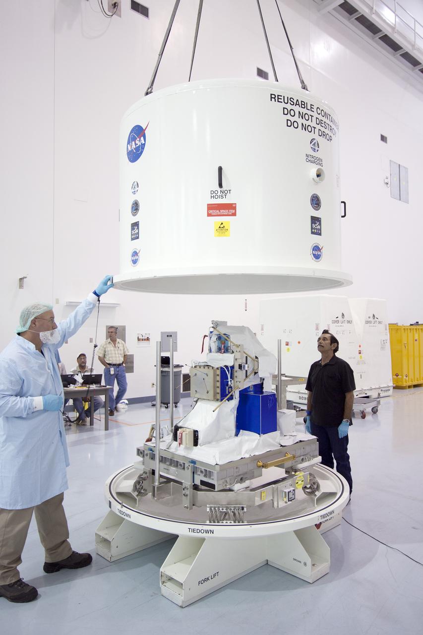 CAPE CANAVERAL, Fla. -- Inside the Space Station Processing Facility at NASA's Kennedy Space Center in Florida, technicians lower the cover of the shipping container that will enclose the Space Test Program-Houston 4 experiment. The experiment is one of the payloads processed at Kennedy that will be flown to Japan for the HTV-4 launch to the station, which is currently scheduled for this summer. Photo credit: NASA/Jim Grossmann