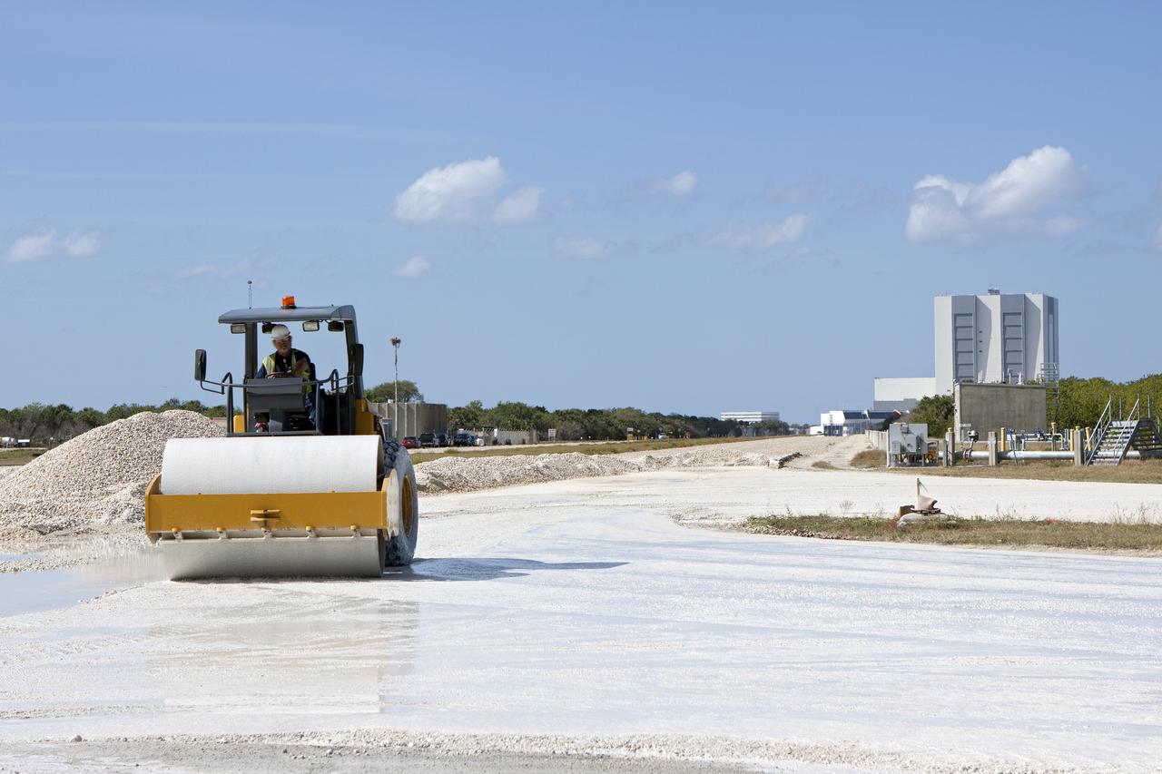 CAPE CANAVERAL, Fla. – A worker from Canaveral Construction in Mims, Fla., re-grades a section of the lime rock on the crawlerway near Launch Pad 39B at NASA’s Kennedy Space Center in Florida.    The crawlerway is being upgraded to improve the foundation and prepare it to support the weight of NASA’s Space Launch System, or SLS, and mobile launcher on the crawler-transporter during rollout. Workers are removing the original Alabama river rock and restoring the layer of lime rock below to its original depth. Then new river rock will be added on top. The Ground Systems Development and Operations, or GSDO, Program office at Kennedy is leading the center’s transformation to safely handle a variety of rockets and spacecraft. For more information about GSDO, visit: http://go.nasa.gov/groundsystems. Photo credit: NASA/Jim Grossmann