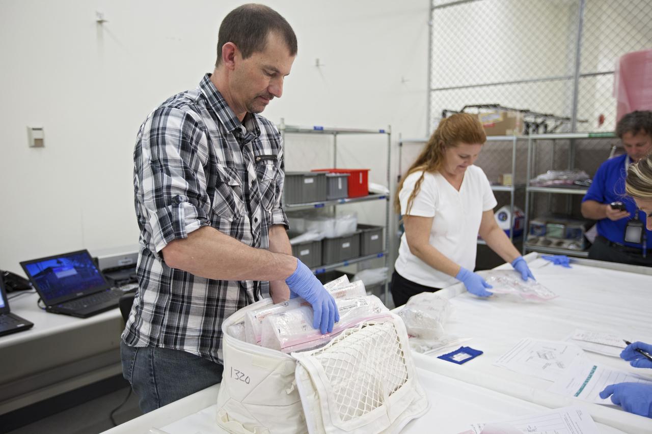 CAPE CANAVERAL, Fla. - In the Space Station Processing Facility at NASA's Kennedy Space Center in Florida, engineers prepare experiments for loading aboard the SpaceX Dragon capsule for launch to the International Space Station. Once the packaging is complete, the samples will be transported to Space Launch Complex-40 on Cape Canaveral Air Force Station where they will be loaded aboard the Dragon.    Scheduled for launch March 1 atop a Falcon 9 rocket, Dragon will be making its third trip to the space station. The mission is the second of 12 SpaceX flights contracted by NASA to resupply the orbiting laboratory. For more information, visit http://www.nasa.gov/mission_pages/station/structure/launch/spacex2-feature.html Photo credit: NASA/Kim Shiflett