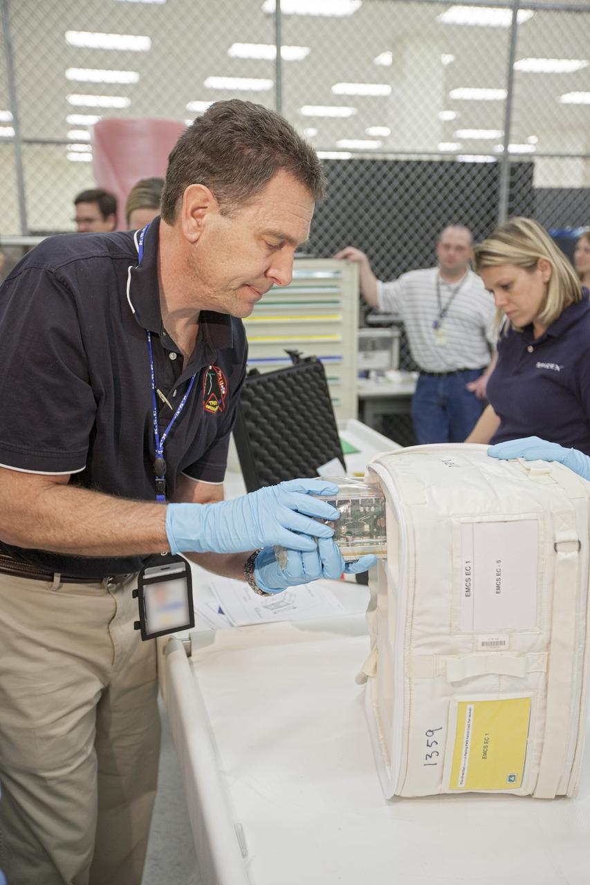 CAPE CANAVERAL, Fla. - In the Space Station Processing Facility at NASA's Kennedy Space Center in Florida, engineers prepare experiments for loading aboard the SpaceX Dragon capsule for launch to the International Space Station. Once the packaging is complete, the samples will be transported to Space Launch Complex-40 on Cape Canaveral Air Force Station where they will be loaded aboard the Dragon.    Scheduled for launch March 1 atop a Falcon 9 rocket, Dragon will be making its third trip to the space station. The mission is the second of 12 SpaceX flights contracted by NASA to resupply the orbiting laboratory. For more information, visit http://www.nasa.gov/mission_pages/station/structure/launch/spacex2-feature.html Photo credit: NASA/Kim Shiflett