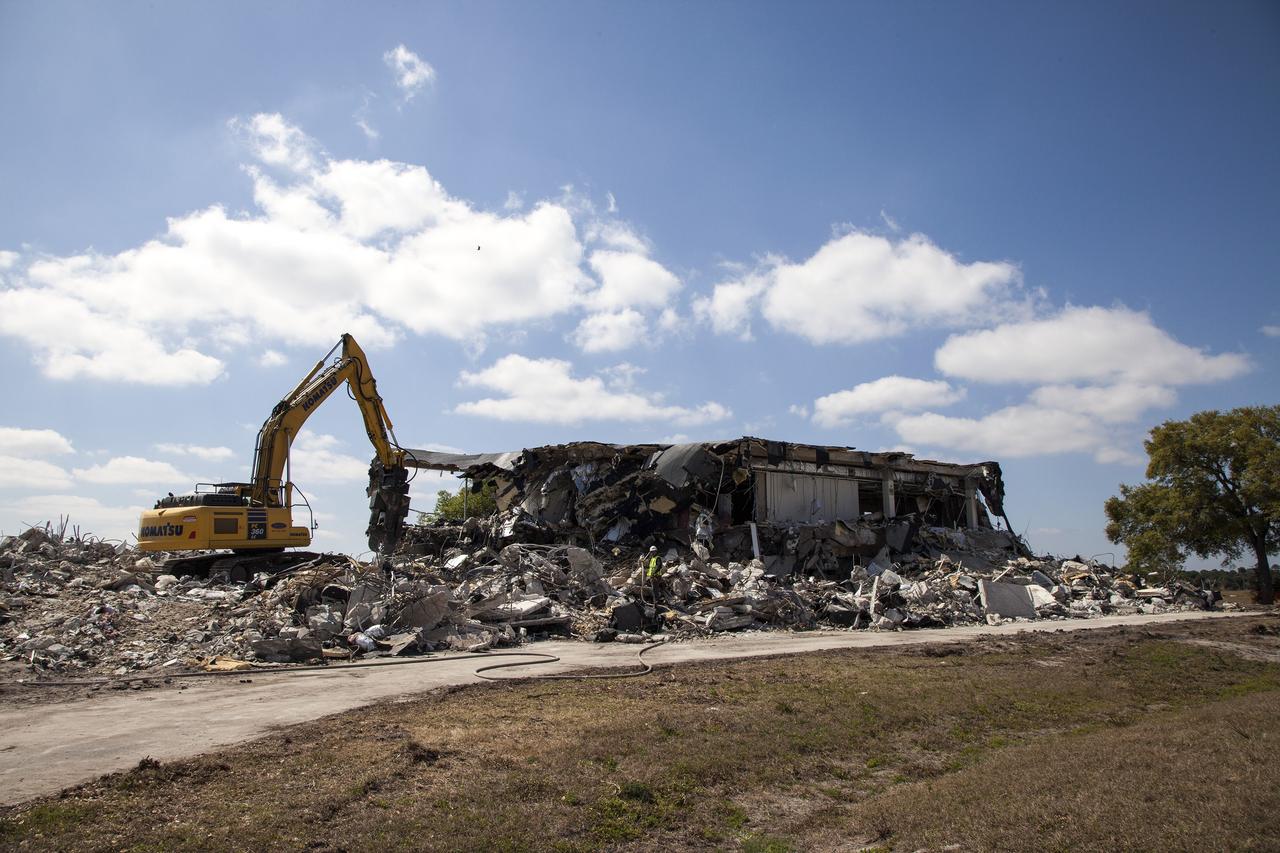 CAPE CANAVERAL, Fla. -- At NASA’s Kennedy Space Center in Florida, demolition is underway on the Base Operations Building, or BOB, in the Industrial Area. Water is being sprayed in the area to control the dust created during the demolition process. The two-story BOB was constructed in 1965 as office space for workers. Kennedy is demolishing some of the older facilities due to their age and to reduce maintenance and repair costs. Photo credit: NASA/Kim Shiflett