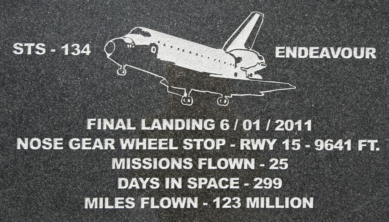 CAPE CANAVERAL, Fla. – At Kennedy Space Center's Shuttle Landing Facility, a granite plaque marks the spot where space shuttle Endeavour's nose gear came to a stop at the conclusion of STS-134, the final flight of the Space Shuttle Program.     Permanent reminders indicate where on the runway the orbiters Discovery, Endeavour and Atlantis stopped rolling as each finished its last mission in 2011. In addition to the granite markers, which are installed alongside the runway, there are etchings in the grooved concrete along the runway's centerline to mark each wheelstop. The etchings and markers were created and installed by local artist Chad Stout of C Spray Glass Blasting in Cocoa, Fla. Photo credit: NASA/Tim Jacobs