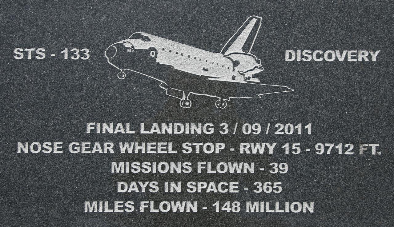 CAPE CANAVERAL, Fla. – At Kennedy Space Center's Shuttle Landing Facility, a granite plaque marks the spot where space shuttle Discovery's nose gear came to a stop at the conclusion of STS-133, the final flight of the Space Shuttle Program.     Permanent reminders indicate where on the runway the orbiters Discovery, Endeavour and Atlantis stopped rolling as each finished its last mission in 2011. In addition to the granite markers, which are installed alongside the runway, there are etchings in the grooved concrete along the runway's centerline to mark each wheelstop. The etchings and markers were created and installed by local artist Chad Stout of C Spray Glass Blasting in Cocoa, Fla. Photo credit: NASA/Tim Jacobs