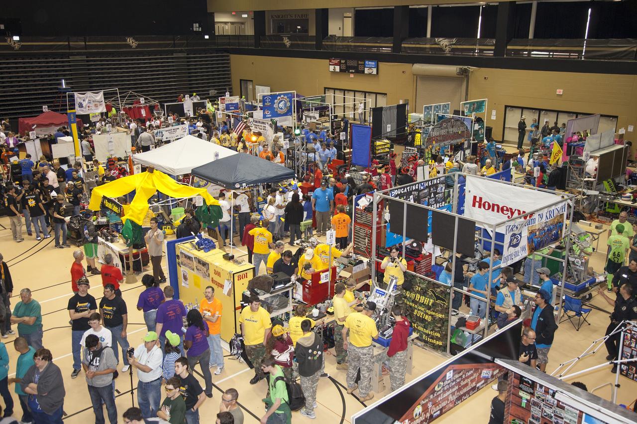 ORLANDO, Fla. – Teams of high school students prepare robots for competition in the Pit Area set up in the University of Central Florida Arena as part of the FIRST Robotics Competition's 2013 Orlando Regional. The student-built robots were required to throw discs into boxes or make climbs to score points. Photo credit: NASA/Frankie Martin