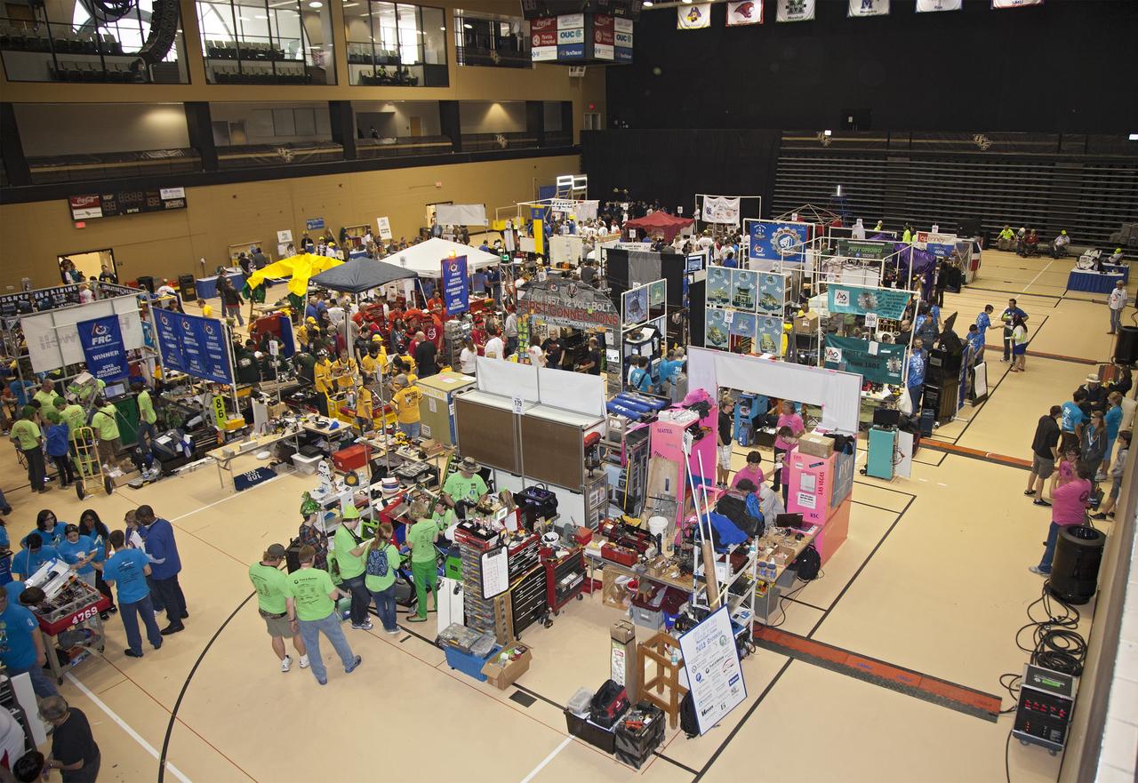 ORLANDO, Fla. – Teams of high school students prepare robots for competition in the Pit Area set up in the University of Central Florida Arena as part of the FIRST Robotics Competition's 2013 Orlando Regional. The student-built robots were required to throw discs into boxes or make climbs to score points. Photo credit: NASA/Frankie Martin