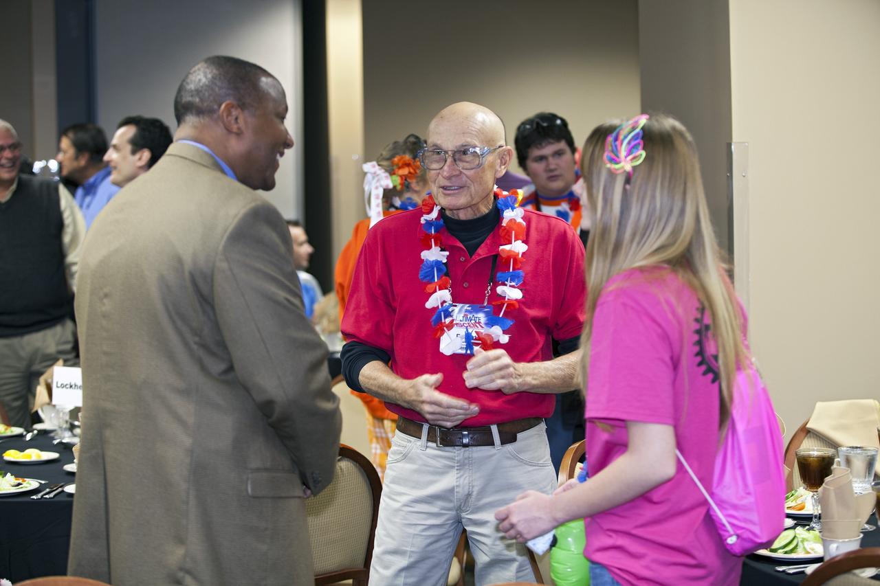 ORLANDO, Fla. – Kelvin Manning, associate director of NASA's Kennedy Space Center in Florida, left, and Bob Seick, former shuttle launch director, talk with a member of The Pink Team taking part in the FIRST Robotics Competition's 2013 Orlando Regional in the University of Central Florida Arena. The student-built robots were required to throw discs into boxes or make climbs to score points. Photo credit: NASA/Frankie Martin