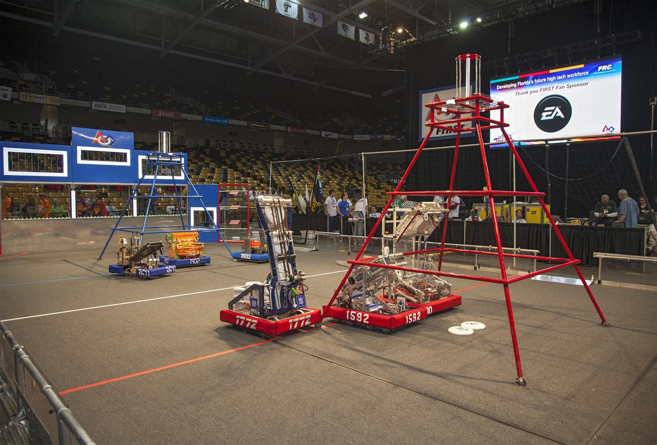 ORLANDO, Fla. – Robots built and operated by teams of high school students compete in the University of Central Florida Arena as part of the FIRST Robotics Competition's 2013 Orlando Regional. The robots were required to throw discs into boxes or make climbs to score points. Photo credit: NASA/Frankie Martin