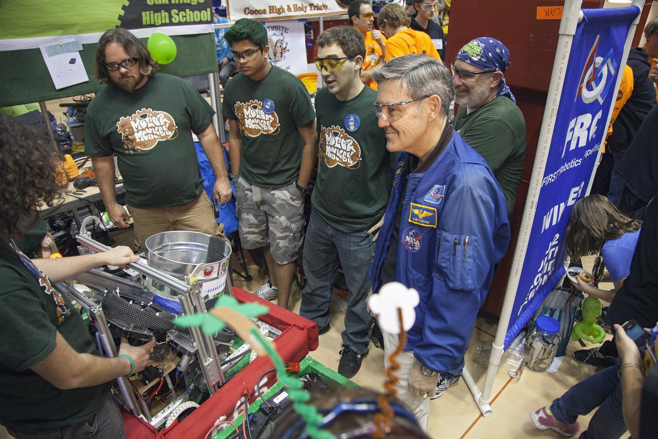 ORLANDO, Fla. – Robert Cabana, director of NASA's Kennedy Space Center in Florida, discusses technological advances with teams of high school students taking part in the FIRST Robotics Competition's 2013 Orlando Regional in the University of Central Florida Arena. The student-built robots were required to throw discs into boxes or make climbs to score points. Photo credit: NASA/Frankie Martin