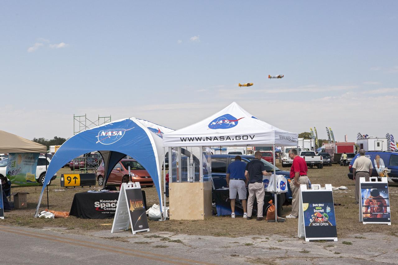 TITUSVILLE, Fla. – Visitors to the Tico Air Show near NASA's Kennedy Space Center in Florida take time to learn about the work the agency is pursuing and plans for future exploration. Visitors to the NASA booth found out about the Ground Systems Development and Operations Program, the Launch Services Program and the Commercial Crew Program, all based at Kennedy. They could also see models of spacecraft and rockets including the Space Launch System, or SLS. Photo credit: NASA/Dimitri Gerondidokis