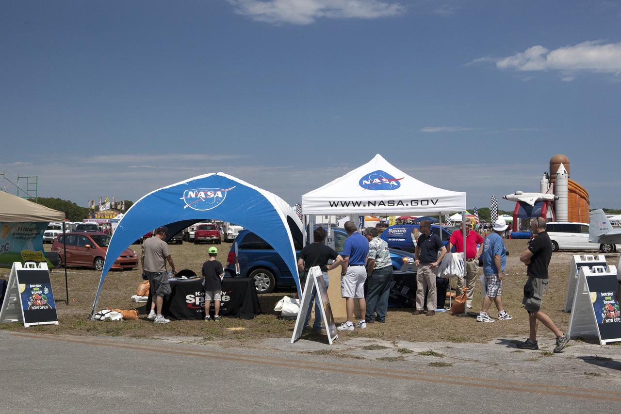 TITUSVILLE, Fla. – Visitors to the Tico Air Show near NASA's Kennedy Space Center in Florida take time to learn about the work the agency is pursuing and plans for future exploration. Visitors to the NASA booth found out about the Ground Systems Development and Operations Program, the Launch Services Program and the Commercial Crew Program, all based at Kennedy. They could also see models of spacecraft and rockets including the Space Launch System, or SLS. Photo credit: NASA/Dimitri Gerondidokis