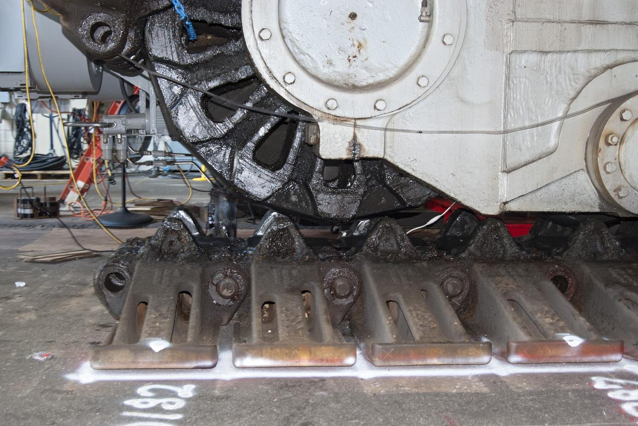 CAPE CANAVERAL, Fla. -- Technicians in the Vehicle Assembly Building at NASA’s Kennedy Space Center in Florida, are preparing to jack crawler-transporter 2, or CT-2, four feet off the floor to facilitate removal of the roller bearing assemblies. After inspections, new assemblies will be installed.      The Ground Systems Development and Operations Program office at Kennedy is overseeing the upgrades to CT-2 so that it can carry NASA’s Space Launch System heavy-lift rocket and new Orion spacecraft to the launch pad. For more than 45 years the crawler-transporters were used to transport the mobile launcher platform and the Apollo-Saturn V rockets and, later, space shuttles to Launch Pads 39A and B. Photo credit: NASA/Charisse Nahser