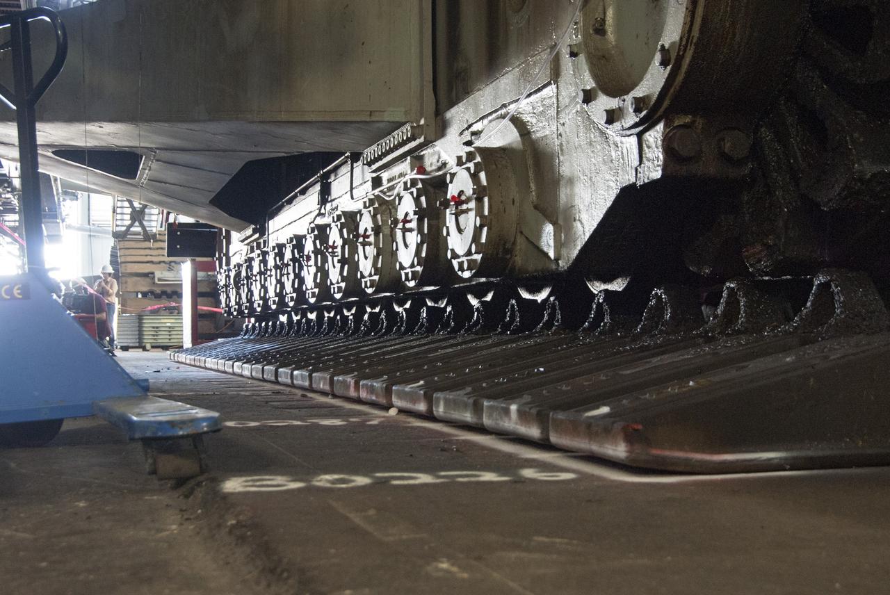 CAPE CANAVERAL, Fla. -- Technicians in the Vehicle Assembly Building at NASA’s Kennedy Space Center in Florida, are preparing to jack crawler-transporter 2, or CT-2, four feet off the floor to facilitate removal of the roller bearing assemblies. After inspections, new assemblies will be installed.      The Ground Systems Development and Operations Program office at Kennedy is overseeing the upgrades to CT-2 so that it can carry NASA’s Space Launch System heavy-lift rocket and new Orion spacecraft to the launch pad. For more than 45 years the crawler-transporters were used to transport the mobile launcher platform and the Apollo-Saturn V rockets and, later, space shuttles to Launch Pads 39A and B. Photo credit: NASA/Charisse Nahser
