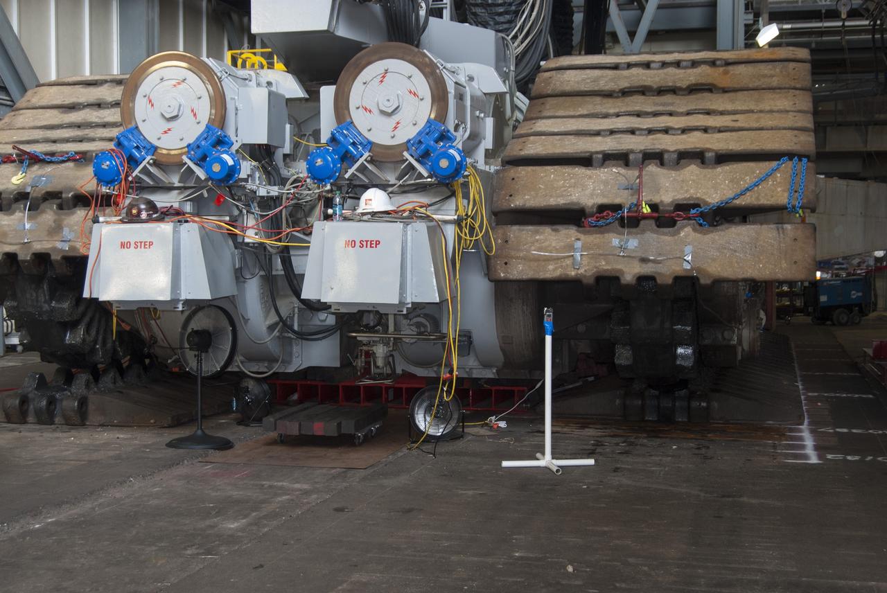 CAPE CANAVERAL, Fla. -- Technicians in the Vehicle Assembly Building at NASA’s Kennedy Space Center in Florida, prepare to jack crawler-transporter 2, or CT-2, four feet off the floor to facilitate removal of the roller bearing assemblies. After inspections, new assemblies will be installed.      The Ground Systems Development and Operations Program office at Kennedy is overseeing the upgrades to CT-2 so that it can carry NASA’s Space Launch System heavy-lift rocket and new Orion spacecraft to the launch pad. For more than 45 years the crawler-transporters were used to transport the mobile launcher platform and the Apollo-Saturn V rockets and, later, space shuttles to Launch Pads 39A and B. Photo credit: NASA/Charisse Nahser