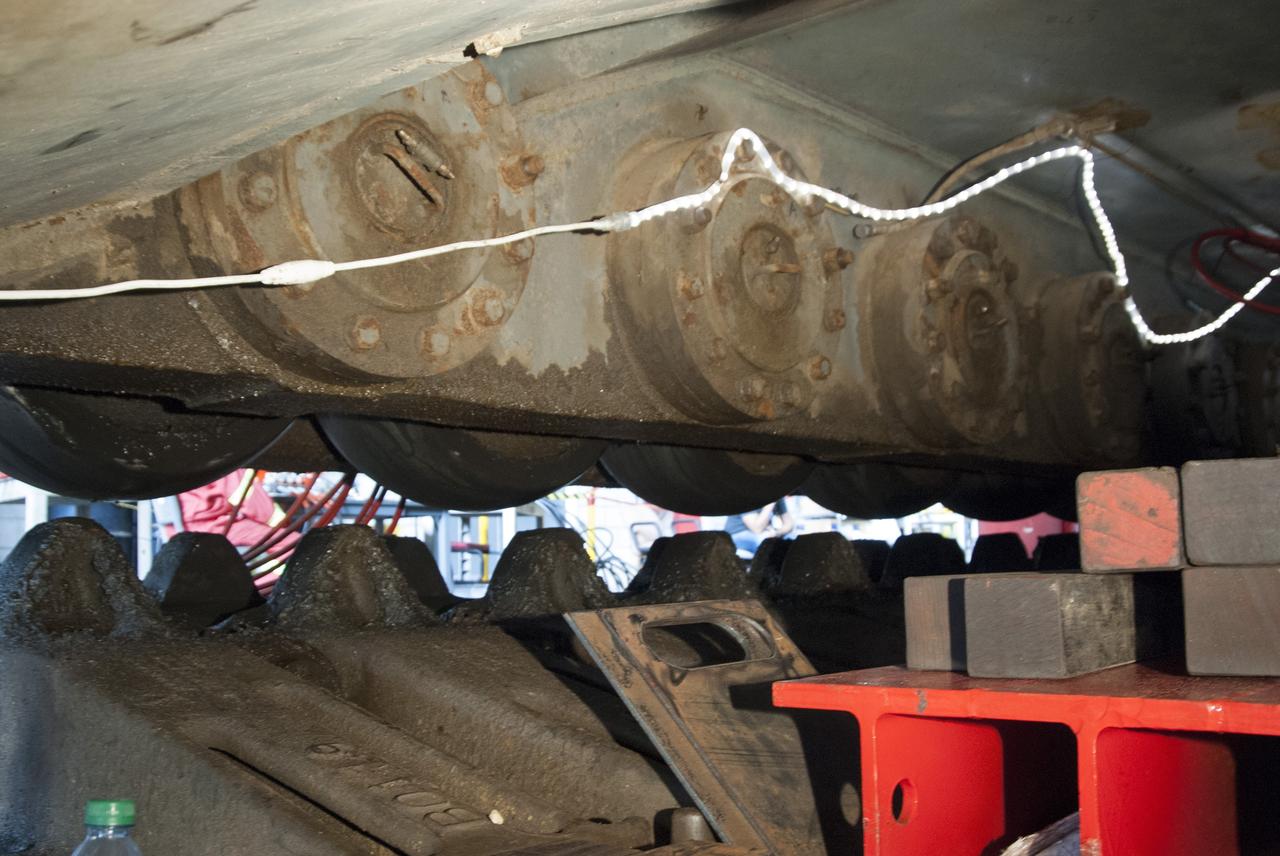 CAPE CANAVERAL, Fla. -- Technicians in the Vehicle Assembly Building at NASA’s Kennedy Space Center in Florida, begin jacking crawler-transporter 2, or CT-2, four feet off the floor to facilitate removal of the roller bearing assemblies. After inspections, new assemblies will be installed.      The Ground Systems Development and Operations Program office at Kennedy is overseeing the upgrades to CT-2 so that it can carry NASA’s Space Launch System heavy-lift rocket and new Orion spacecraft to the launch pad. For more than 45 years the crawler-transporters were used to transport the mobile launcher platform and the Apollo-Saturn V rockets and, later, space shuttles to Launch Pads 39A and B. Photo credit: NASA/Charisse Nahser