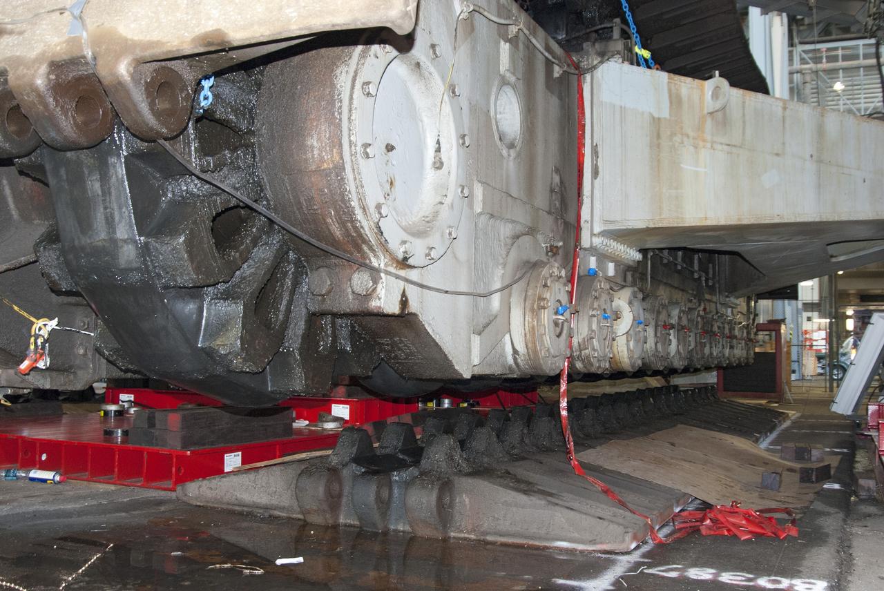 CAPE CANAVERAL, Fla. -- Technicians in the Vehicle Assembly Building at NASA’s Kennedy Space Center in Florida, are jacking crawler-transporter 2, or CT-2, four feet off the floor to facilitate removal of the roller bearing assemblies. After inspections, new assemblies will be installed.      The Ground Systems Development and Operations Program office at Kennedy is overseeing the upgrades to CT-2 so that it can carry NASA’s Space Launch System heavy-lift rocket and new Orion spacecraft to the launch pad. For more than 45 years the crawler-transporters were used to transport the mobile launcher platform and the Apollo-Saturn V rockets and, later, space shuttles to Launch Pads 39A and B. Photo credit: NASA/Charisse Nahser