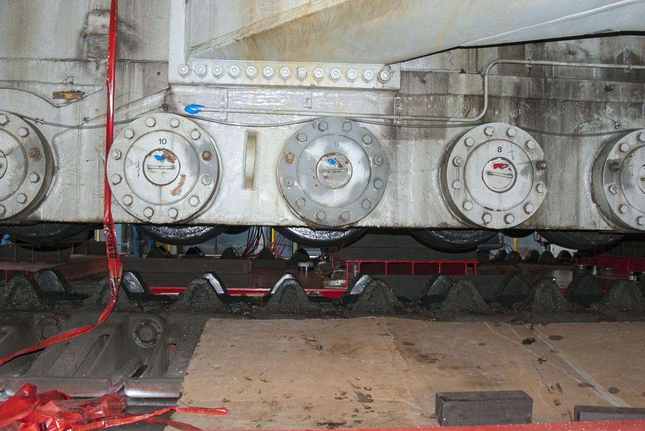 CAPE CANAVERAL, Fla. -- Technicians in the Vehicle Assembly Building at NASA’s Kennedy Space Center in Florida, are jacking crawler-transporter 2, or CT-2, four feet off the floor to facilitate removal of the roller bearing assemblies. After inspections, new assemblies will be installed.      The Ground Systems Development and Operations Program office at Kennedy is overseeing the upgrades to CT-2 so that it can carry NASA’s Space Launch System heavy-lift rocket and new Orion spacecraft to the launch pad. For more than 45 years the crawler-transporters were used to transport the mobile launcher platform and the Apollo-Saturn V rockets and, later, space shuttles to Launch Pads 39A and B. Photo credit: NASA/Charisse Nahser