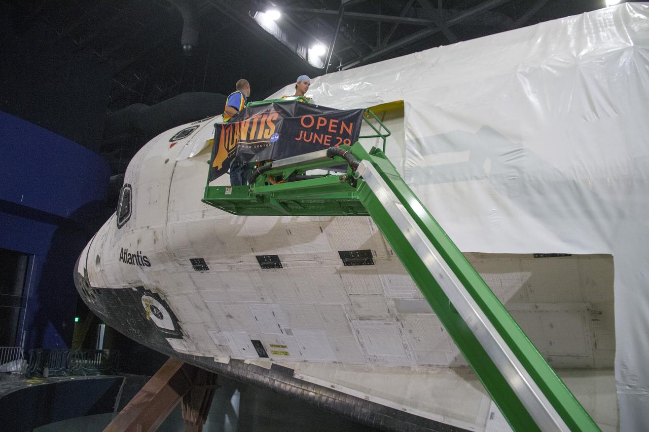 CAPE CANAVERAL, Fla. -- At the Kennedy Space Center Visitor Complex in Florida, construction crews are removing 16,000 square feet of plastic shrink-wrap from the space shuttle Atlantis. The spacecraft was enclosed in the plastic shrink-wrap since November of last year to protect the artifact from dust and debris during construction of the 90,000-square-foot facility. Last November, the space shuttle Atlantis made its historic final journey to its new home, traveling 10 miles from the Kennedy Space Center's Vehicle Assembly Building to the spaceport's visitor complex. The new $100 million "Space Shuttle Atlantis" facility will include interactive exhibits that tell the story of the 30-year Space Shuttle Program and highlights the future of space exploration. The "Space Shuttle Atlantis" exhibit scheduled to open June 29, 2013.Photo credit: NASA/Cory Huston