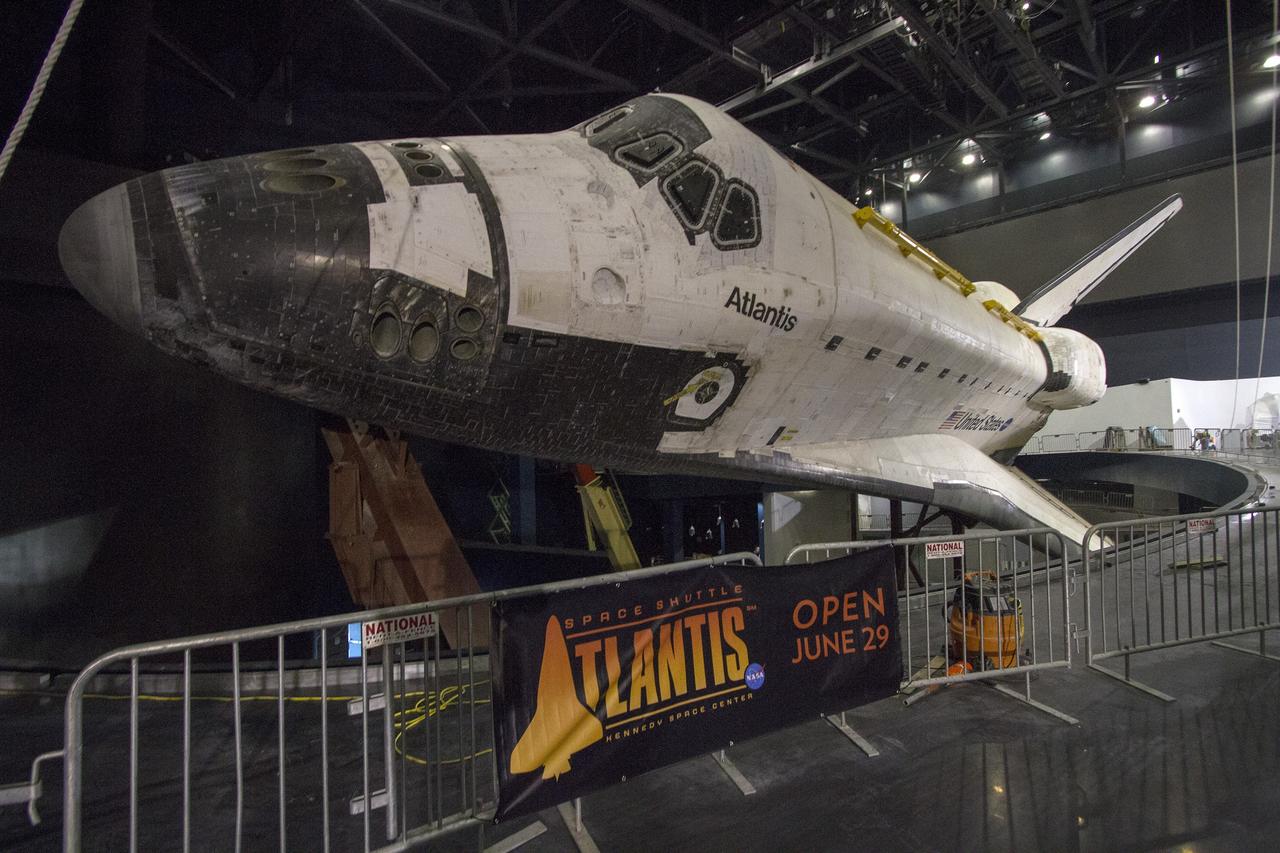 CAPE CANAVERAL, Fla. -- At the Kennedy Space Center Visitor Complex in Florida, construction crews have removed 16,000 square feet of plastic shrink-wrap from the space shuttle Atlantis. The spacecraft was enclosed in the plastic shrink-wrap since November of last year to protect the artifact from dust and debris during construction of the 90,000-square-foot facility. Last November, the space shuttle Atlantis made its historic final journey to its new home, traveling 10 miles from the Kennedy Space Center's Vehicle Assembly Building to the spaceport's visitor complex. The new $100 million "Space Shuttle Atlantis" facility will include interactive exhibits that tell the story of the 30-year Space Shuttle Program and highlights the future of space exploration. The "Space Shuttle Atlantis" exhibit scheduled to open June 29, 2013.Photo credit: NASA/Cory Huston