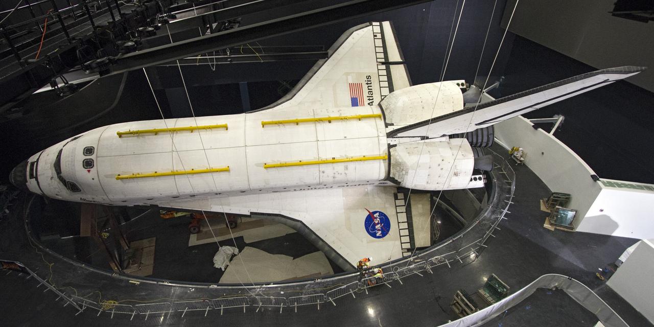 CAPE CANAVERAL, Fla. -- At the Kennedy Space Center Visitor Complex in Florida, construction crews have removed 16,000 square feet of plastic shrink-wrap from the space shuttle Atlantis. The spacecraft was enclosed in the plastic shrink-wrap since November of last year to protect the artifact from dust and debris during construction of the 90,000-square-foot facility. Last November, the space shuttle Atlantis made its historic final journey to its new home, traveling 10 miles from the Kennedy Space Center's Vehicle Assembly Building to the spaceport's visitor complex. The new $100 million "Space Shuttle Atlantis" facility will include interactive exhibits that tell the story of the 30-year Space Shuttle Program and highlights the future of space exploration. The "Space Shuttle Atlantis" exhibit scheduled to open June 29, 2013.Photo credit: NASA/Cory Huston