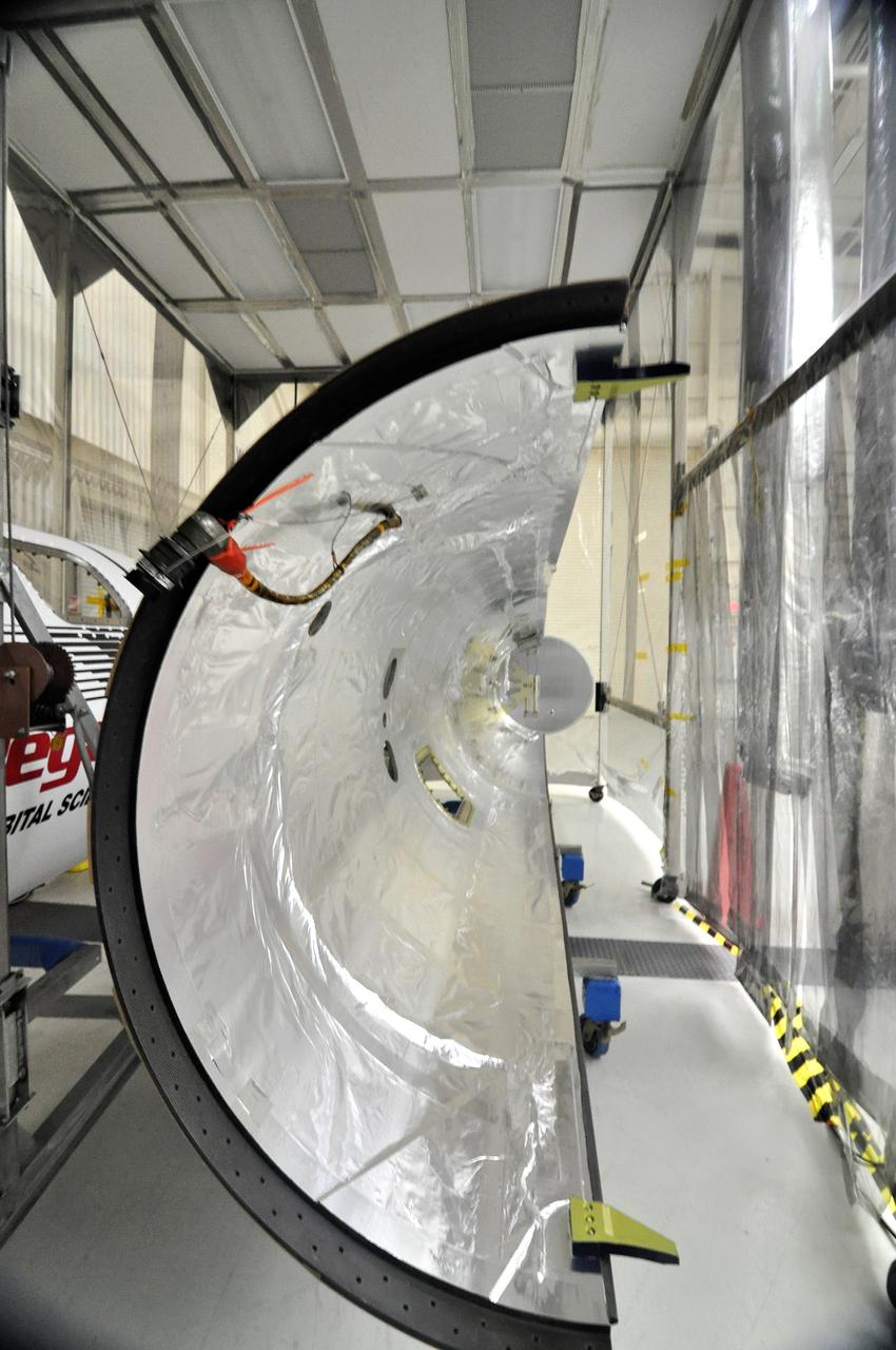 VANDENBERG AIR FORCE BASE, Calif. -- Half of the fairing that will be fitted to the nose of the Orbital Sciences Corp. Pegasus XL rocket is ready for its installation around the Interface Region Imaging Spectrograph, or IRIS, spacecraft. The fairing will protect the spacecraft from atmospheric heating and stress during launch.                  IRIS will open a new window of discovery by tracing the flow of energy and plasma through the chromospheres and transition region into the sun’s corona using spectrometry and imaging. IRIS fills a crucial gap in our ability to advance studies of the sun-to-Earth connection by tracing the flow of energy and plasma through the foundation of the corona and the region around the sun known as the heliosphere.  Photo credit: VAFB/Randy Beaudoin