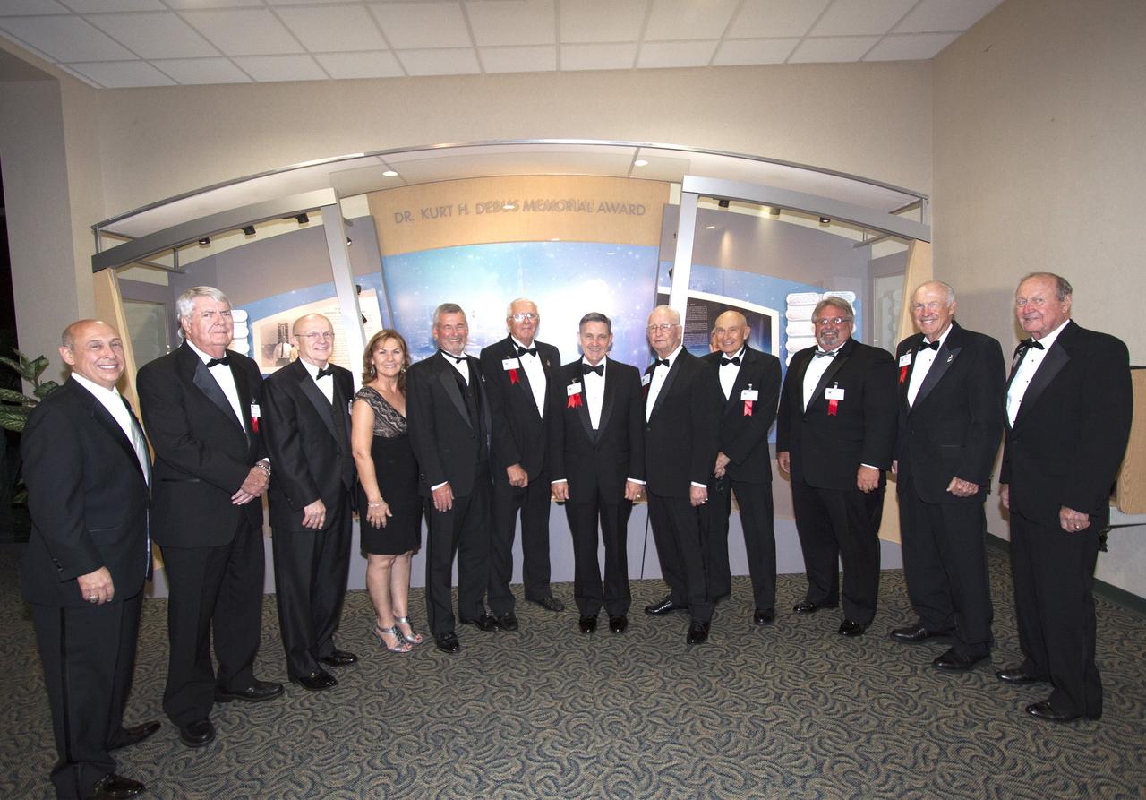 CAPE CANAVERAL, Fla. – At NASA’s Kennedy Space Center Visitor Complex in Florida, previous winners of the National Space Club Florid Committee's Dr. Kurt H. Debus Award pose with this year's honoree, center director Bob Cabana. From the left, are: Rick Abramson, Dick Beagley, Dick Lyon, Patty Stratton, Lyle Holloway, Lee Solid, Cabana, Dr. Maxwell King, Bob Sieck, Jerry Jamison, Roy Tharpe and Ernie Briel. A former U.S. Marine Corps aviator and NASA astronaut, Cabana was honored at the gala Debus Award Dinner. Named for the spaceport’s first director, the Debus Award was created to recognize significant achievements and contributions made in Florida to American aerospace efforts. The Debus Award was created by the space club's Florida committee to recognize significant achievements and contributions made in Florida to American aerospace efforts. Photo credit: NASA/Jim Grossmann