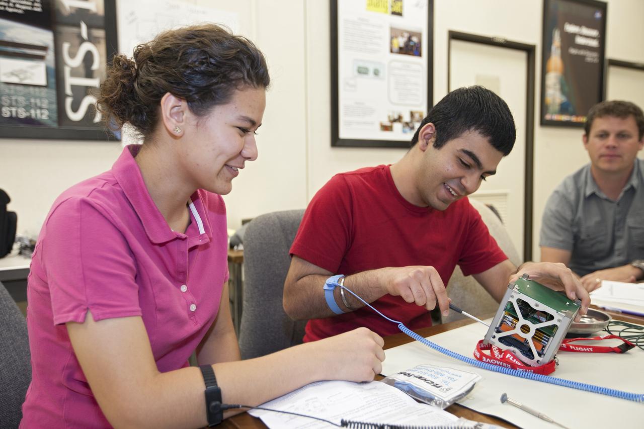 CAPE CANAVERAL, Fla. – Students from Merritt Island High School in Florida perform integration tests a cubesat called StangSat they will fly on a suborbital mission in the summer. The satellite will work inside a small rocket to measure vibration and other data during launch. NASA engineers are acting as mentors for the project and some of the space agency's labs at Kennedy Space Center, including this one inside the Operations and Checkout Building, are being used by the teams. Photo credit: NASA/Kim Shiflett