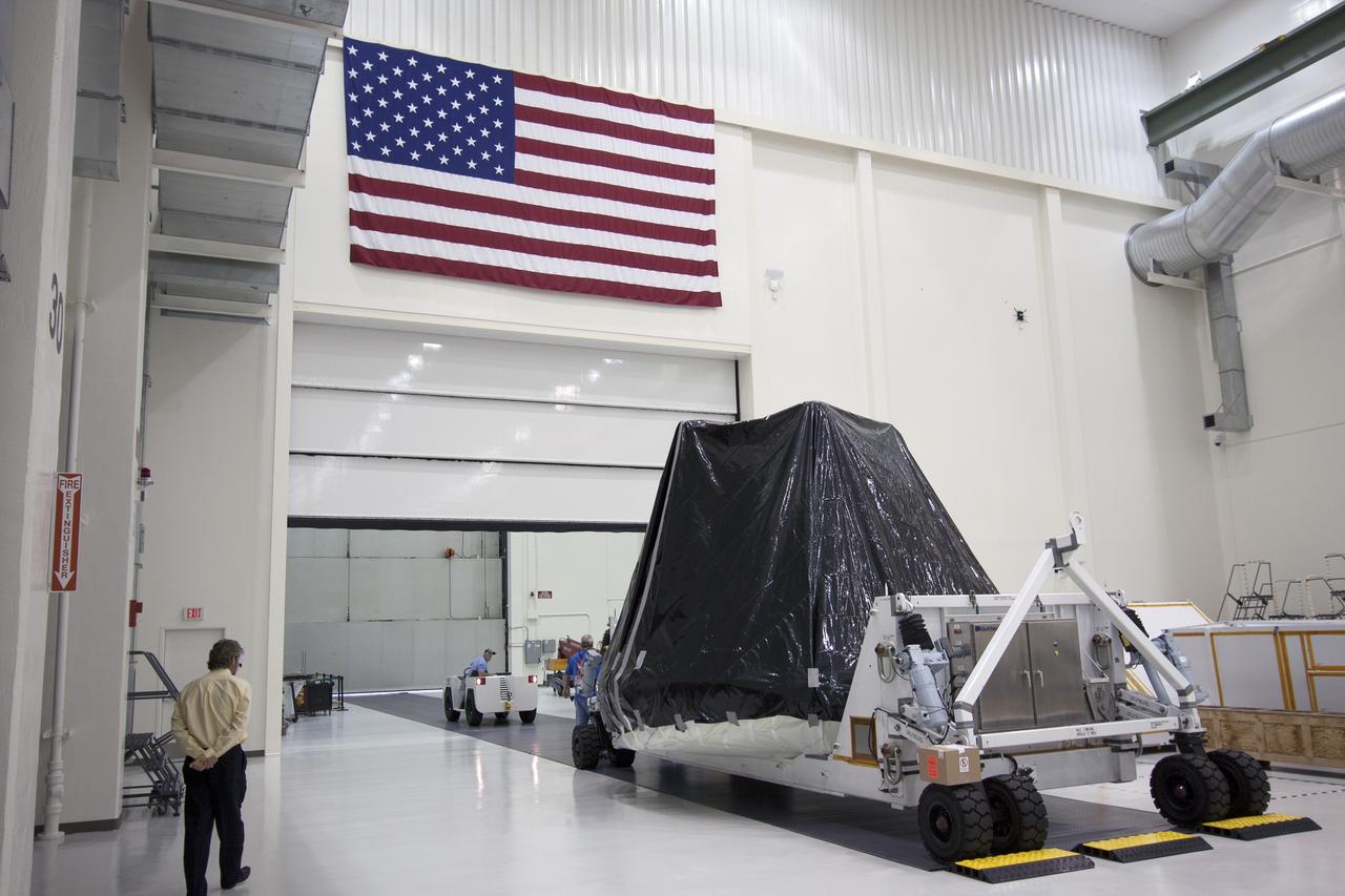 CAPE CANAVERAL, Fla. -- At NASA’s Kennedy Space Center in Florida, workers prepare to move the Orion ground test vehicle, or GTA, from the Operations and Checkout Building to the Launch Equipment Test Facility, or LETF. At the LETF, Lockheed Martin will put the GTA through a series of pyrotechnic bolt tests. The ground test vehicle is being used for path finding operations in the O&C, including simulated manufacturing and assembly procedures.    Launching atop NASA's heavy-lift Space Launch System SLS, which also is under development, the Orion Multi-Purpose Crew Vehicle MPCV will serve as the exploration vehicle that will carry astronaut crews beyond low Earth orbit. It also will provide emergency abort capabilities, sustain the crew during space travel and provide safe re-entry from deep space return velocities. For more information, visit www.nasa.gov/orion. Photo credit: Jim Grossman