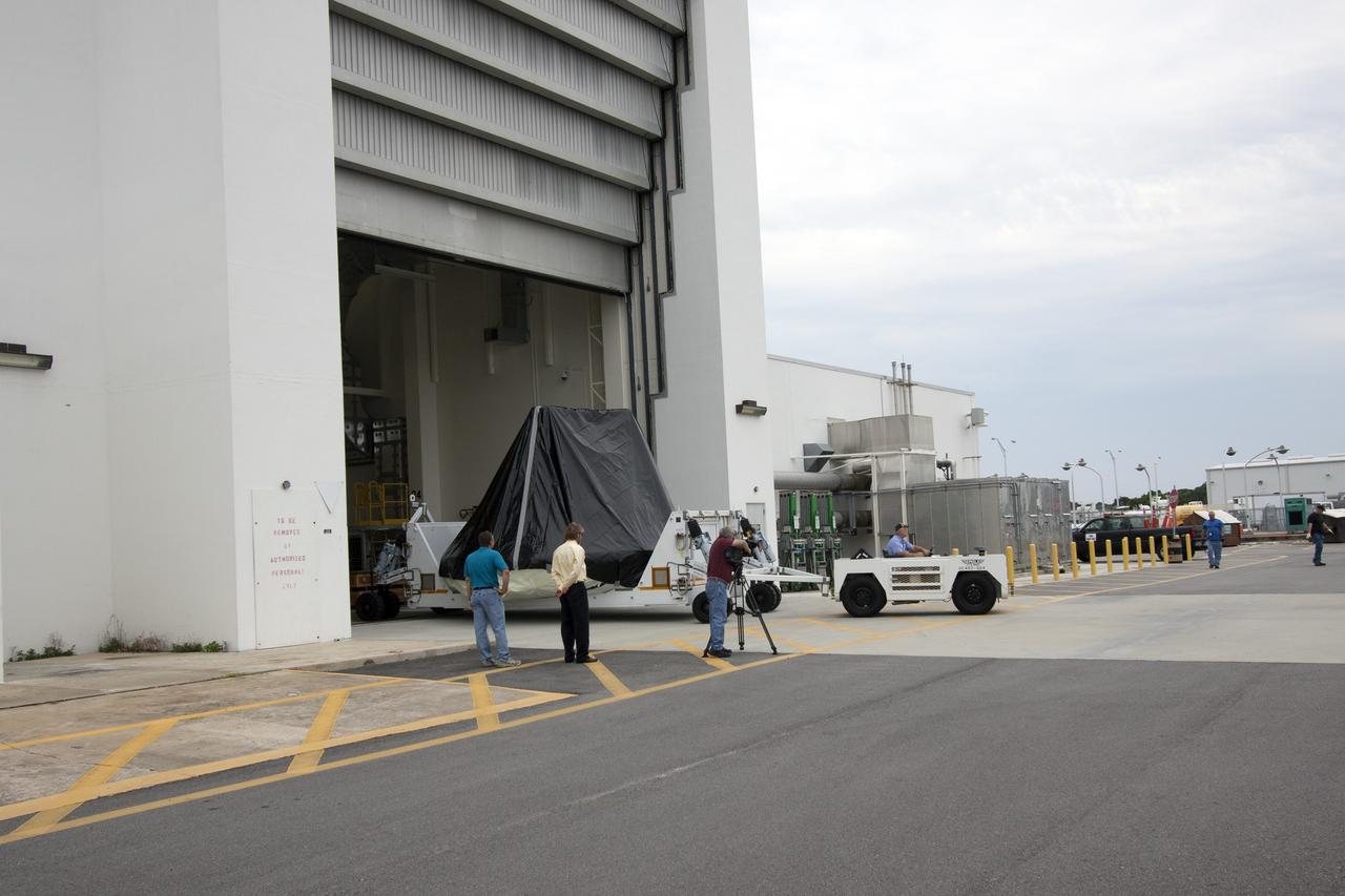 CAPE CANAVERAL, Fla. -- At NASA’s Kennedy Space Center in Florida, workers move the Orion ground test vehicle, or GTA, from the Operations and Checkout Building to the Launch Equipment Test Facility, or LETF. At the LETF, Lockheed Martin will put the GTA through a series of pyrotechnic bolt tests. The ground test vehicle is being used for path finding operations in the O&C, including simulated manufacturing and assembly procedures.    Launching atop NASA's heavy-lift Space Launch System SLS, which also is under development, the Orion Multi-Purpose Crew Vehicle MPCV will serve as the exploration vehicle that will carry astronaut crews beyond low Earth orbit. It also will provide emergency abort capabilities, sustain the crew during space travel and provide safe re-entry from deep space return velocities. For more information, visit www.nasa.gov/orion. Photo credit: Jim Grossman
