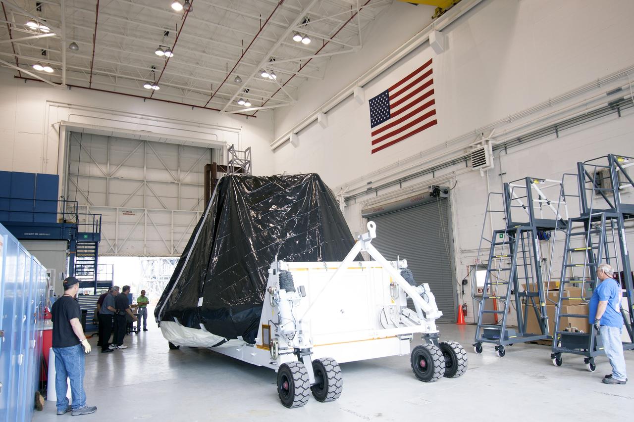 CAPE CANAVERAL, Fla. -- At NASA’s Kennedy Space Center in Florida, workers move the Orion ground test vehicle, or GTA, into the Launch Equipment Test Facility, or LETF, from the Operations and Checkout Building. At the LETF, Lockheed Martin will put the GTA through a series of pyrotechnic bolt tests. The ground test vehicle is being used for path finding operations in the O&C, including simulated manufacturing and assembly procedures.    Launching atop NASA's heavy-lift Space Launch System SLS, which also is under development, the Orion Multi-Purpose Crew Vehicle MPCV will serve as the exploration vehicle that will carry astronaut crews beyond low Earth orbit. It also will provide emergency abort capabilities, sustain the crew during space travel and provide safe re-entry from deep space return velocities. For more information, visit www.nasa.gov/orion. Photo credit: Jim Grossman