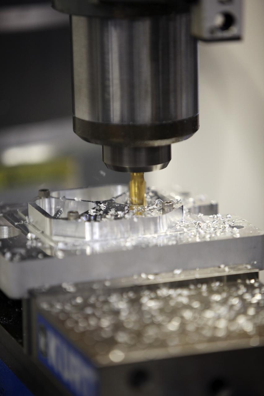 CAPE CANAVERAL, Fla. – A component is machined for a cubesat that is being assembled for launch in June. The component, being machined at NASA's Kennedy Space Center in Florida will hold accelerometers for the StangSat, which is a project whose development includes students from Merritt Island High School in Florida. The satellite will work inside a small rocket to measure vibration and collect other data during launch. NASA engineers are acting as mentors for the project. Photo credit: NASA/Dmitri Gerondidakis