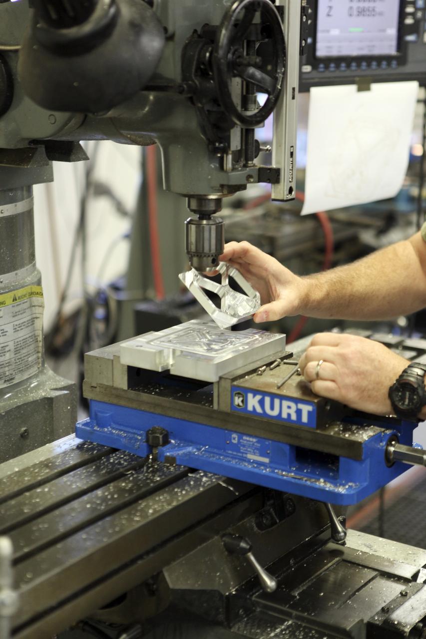 CAPE CANAVERAL, Fla. – A component is machined for a cubesat that is being assembled for launch in June. The component, being machined at NASA's Kennedy Space Center in Florida will hold accelerometers for the StangSat, which is a project whose development includes students from Merritt Island High School in Florida. The satellite will work inside a small rocket to measure vibration and collect other data during launch. NASA engineers are acting as mentors for the project. Photo credit: NASA/Dmitri Gerondidakis