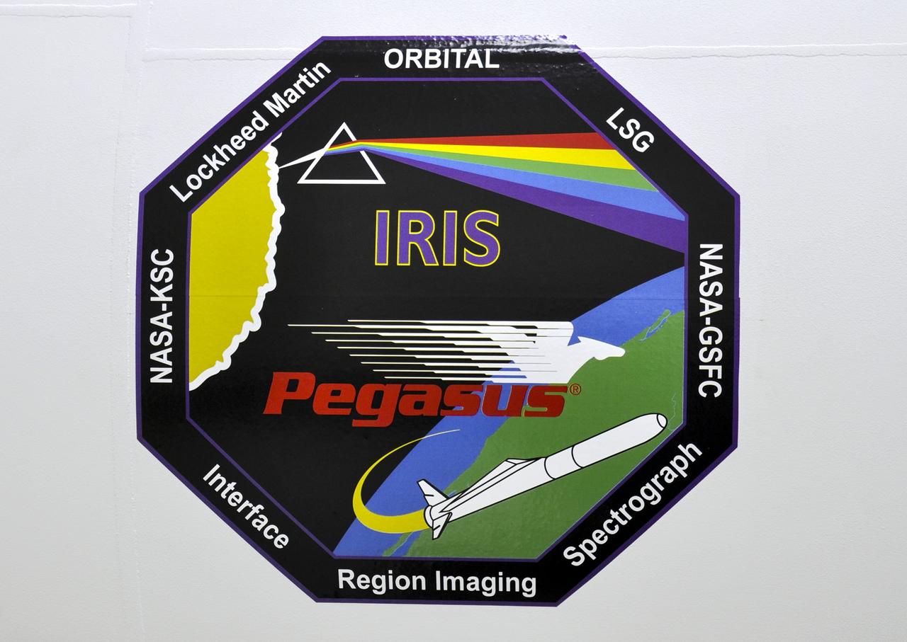 VANDENBERG AFB, Calif. - A mission logo decal for the launch of NASA's IRIS solar observatory aboard an Orbital Sciences Pegasus XL rocket. The decal is on the side of the Pegasus. Engineers are working inside a hangar at Vandenberg Air Force Base where IRIS, short for Interface Region Imaging Spectrograph, is being prepared for launch. Scheduled for launch from Vandenberg June 26, IRIS will open a new window of discovery by tracing the flow of energy and plasma through the chromospheres and transition region into the sun’s corona using spectrometry and imaging. IRIS fills a crucial gap in our ability to advance studies of the sun-to-Earth connection by tracing the flow of energy and plasma through the foundation of the corona and the region around the sun known as the heliosphere. Photo credit: NASA/Randy Beaudoin
