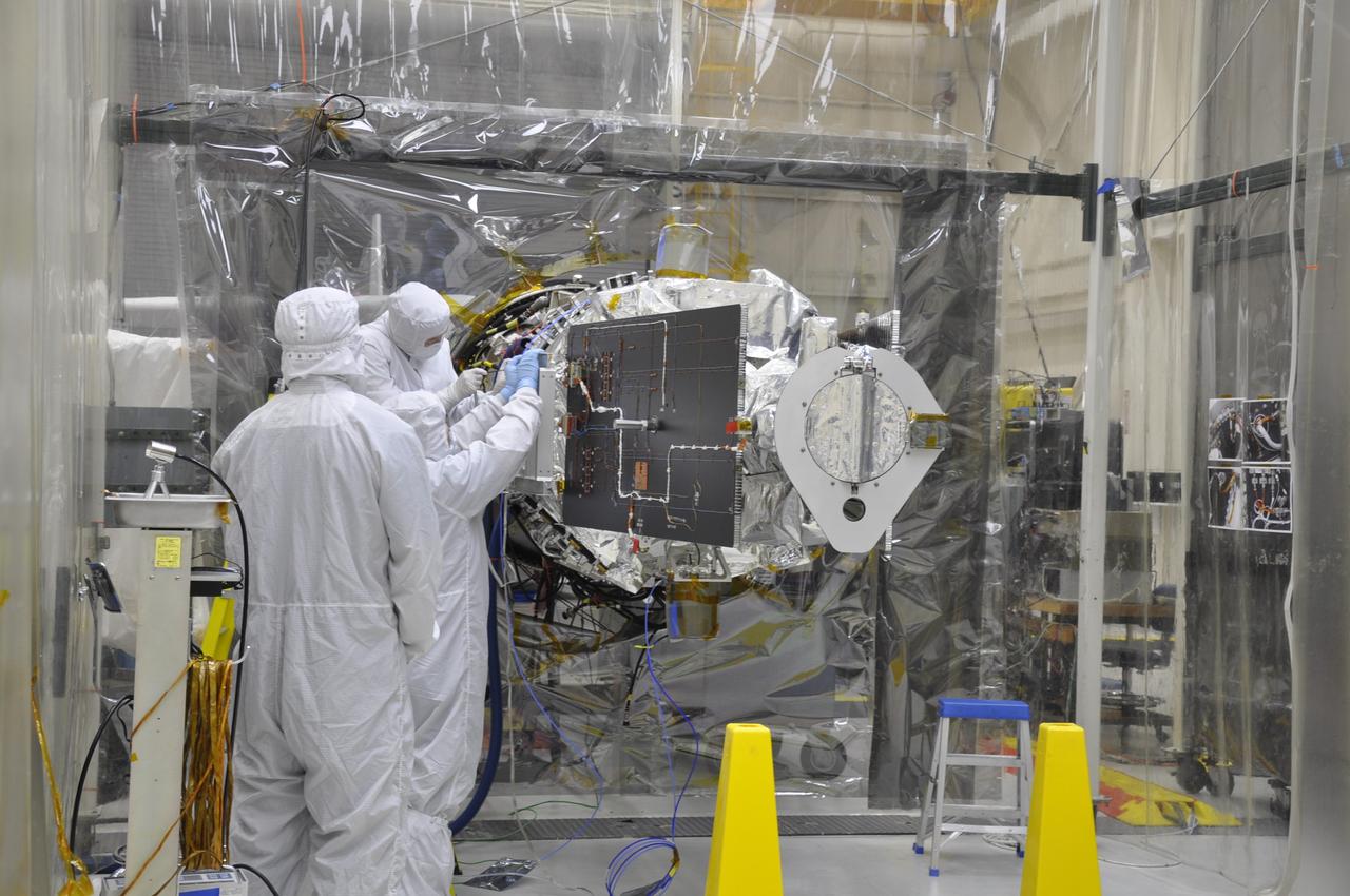 VANDENBERG AFB, Calif. – Engineers unwrap NASA's IRIS spacecraft after its connection to the nose of an Orbital Sciences Pegasus XL rocket that will lift the solar observatory into orbit in June. The work is taking place in a hangar at Vandenberg Air Force Base where IRIS, short for Interface Region Imaging Spectrograph, is being prepared for launch on a Pegasus XL rocket. Scheduled for launch from Vandenberg no earlier than June 26, 2013, IRIS will open a new window of discovery by tracing the flow of energy and plasma through the chromospheres and transition region into the sun’s corona using spectrometry and imaging. IRIS fills a crucial gap in our ability to advance studies of the sun-to-Earth connection by tracing the flow of energy and plasma through the foundation of the corona and the region around the sun known as the heliosphere. Photo credit: NASA/Randy Beaudoin