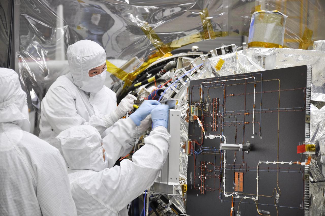 VANDENBERG AFB, Calif. – Engineers unwrap NASA's IRIS spacecraft after its connection to the nose of an Orbital Sciences Pegasus XL rocket that will lift the solar observatory into orbit in June. The work is taking place in a hangar at Vandenberg Air Force Base where IRIS, short for Interface Region Imaging Spectrograph, is being prepared for launch on a Pegasus XL rocket. Scheduled for launch from Vandenberg no earlier than June 26, 2013, IRIS will open a new window of discovery by tracing the flow of energy and plasma through the chromospheres and transition region into the sun’s corona using spectrometry and imaging. IRIS fills a crucial gap in our ability to advance studies of the sun-to-Earth connection by tracing the flow of energy and plasma through the foundation of the corona and the region around the sun known as the heliosphere. Photo credit: NASA/Randy Beaudoin