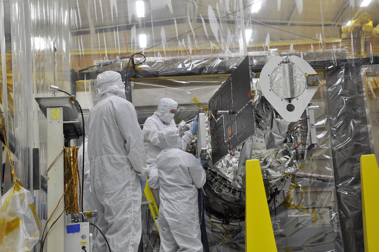 VANDENBERG AFB, Calif. – Engineers unwrap NASA's IRIS spacecraft after its connection to the nose of an Orbital Sciences Pegasus XL rocket that will lift the solar observatory into orbit in June. The work is taking place in a hangar at Vandenberg Air Force Base where IRIS, short for Interface Region Imaging Spectrograph, is being prepared for launch on a Pegasus XL rocket. Scheduled for launch from Vandenberg June 26, IRIS will open a new window of discovery by tracing the flow of energy and plasma through the chromospheres and transition region into the sun’s corona using spectrometry and imaging. IRIS fills a crucial gap in our ability to advance studies of the sun-to-Earth connection by tracing the flow of energy and plasma through the foundation of the corona and the region around the sun known as the heliosphere. Photo credit: NASA/Randy Beaudoin
