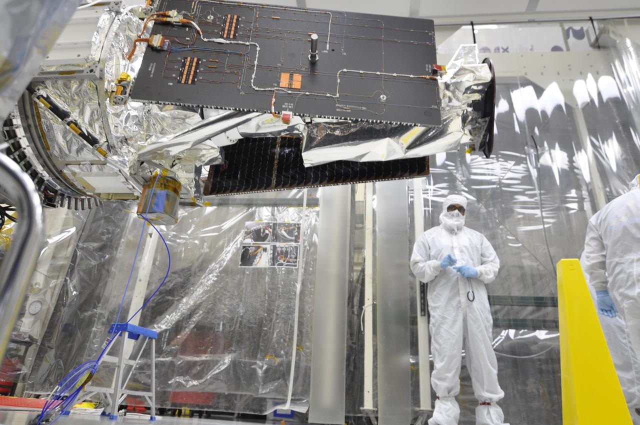 VANDENBERG AFB, Calif. – Engineers unwrap NASA's IRIS spacecraft after its connection to the nose of an Orbital Sciences Pegasus XL rocket that will lift the solar observatory into orbit in June. The work is taking place in a hangar at Vandenberg Air Force Base where IRIS, short for Interface Region Imaging Spectrograph, is being prepared for launch on a Pegasus XL rocket. Scheduled for launch from Vandenberg June 26, IRIS will open a new window of discovery by tracing the flow of energy and plasma through the chromospheres and transition region into the sun’s corona using spectrometry and imaging. IRIS fills a crucial gap in our ability to advance studies of the sun-to-Earth connection by tracing the flow of energy and plasma through the foundation of the corona and the region around the sun known as the heliosphere. Photo credit: NASA/Randy Beaudoin